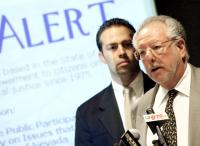 County Commission Chairman Dario Hererra, left, looks on as Mayor Oscar Goodman talks during a news conference at City Hall. 